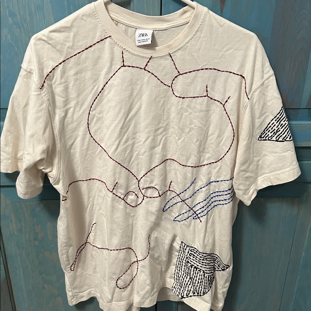 Zara Beige T-Shirt with Abstract Red, Blue and Black Design